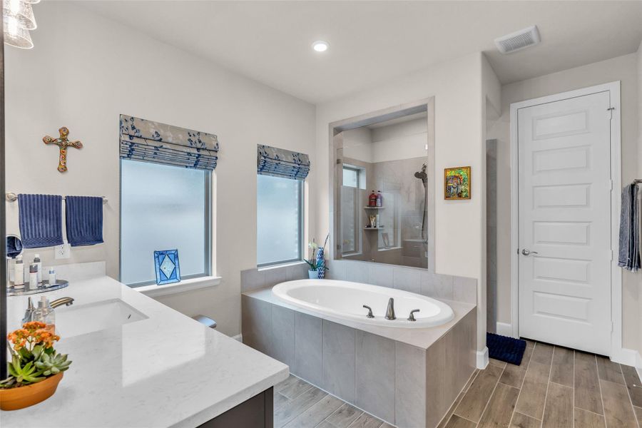 The luxurious spa-like primary bath includes soaking tub and walk-in shower. The luxurious spa-like primary bath includes soaking tub and walk-in shower.