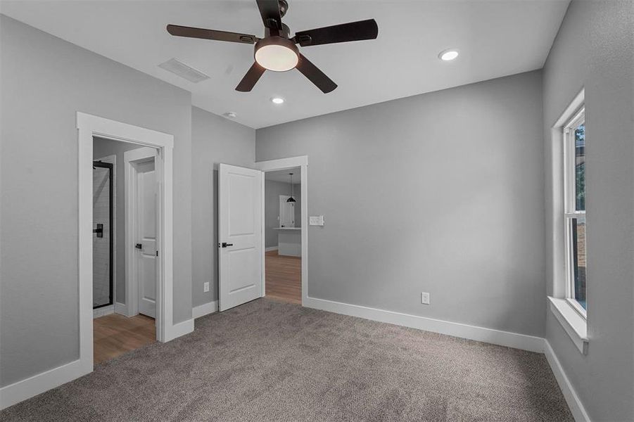 Unfurnished bedroom with ceiling fan and carpet floors