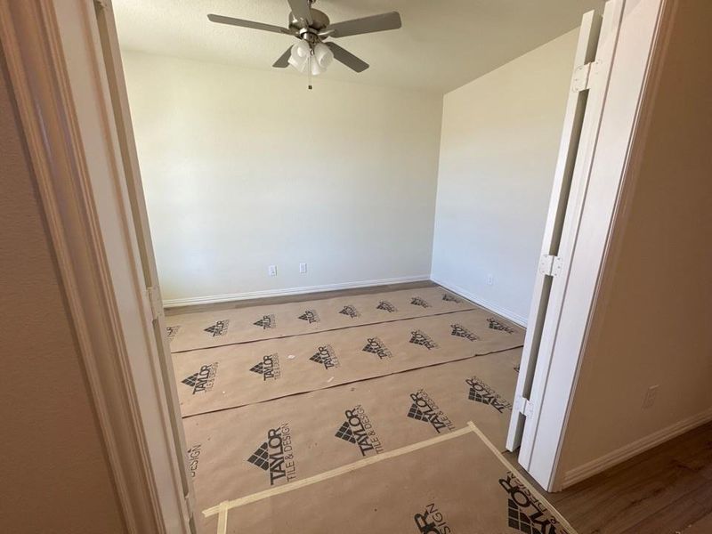 Empty room featuring baseboards and a ceiling fan