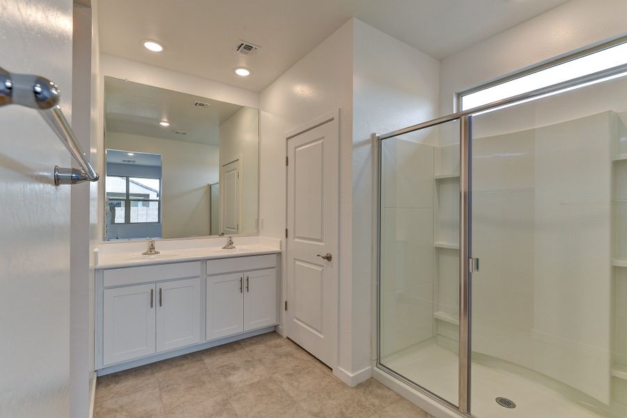 The Olive floorplans primary bathroom with dual sinks.