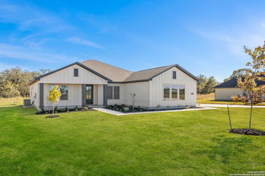Front exterior of a new home in Pradera Ridge, Floresville, TX, highlighting curb appeal (Image 19). Front exterior of a new home in Pradera Ridge, Floresville, TX, highlighting curb appeal (Image 19).