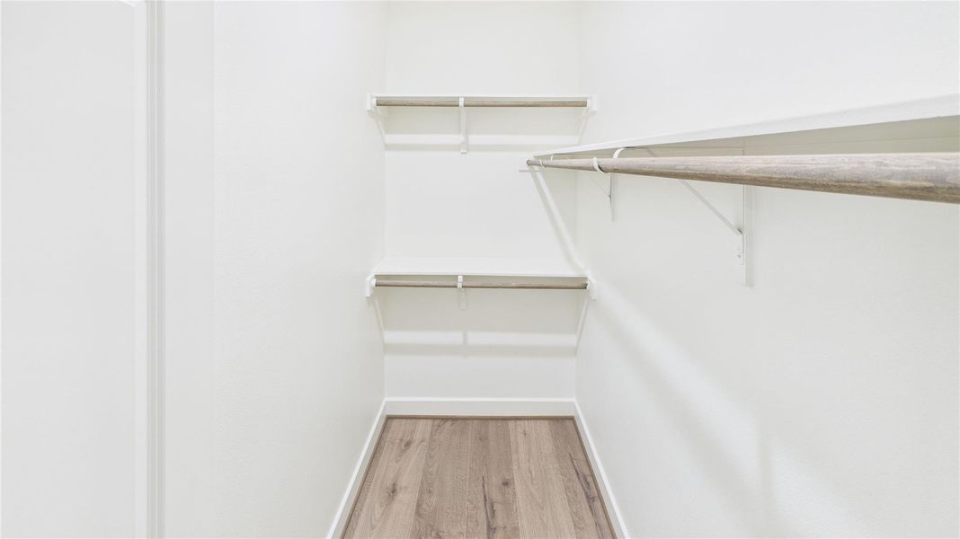 Secondary closet with ample storage.