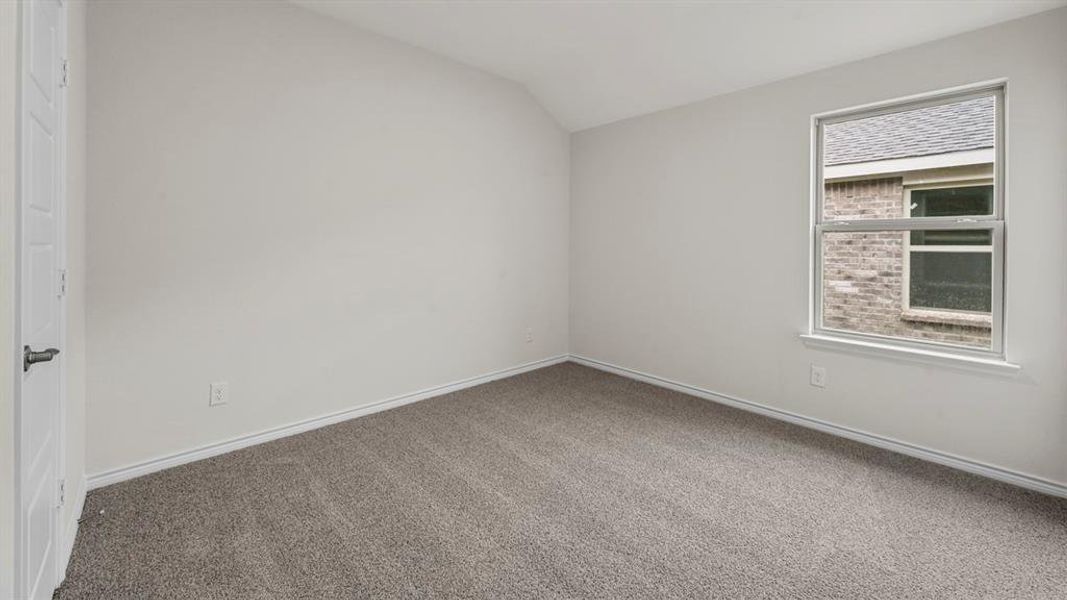 Carpeted room featuring a single window and a paneled door