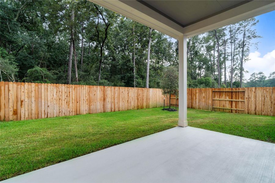 Covered patio overlooks a private, fully fenced backyard. Covered patio overlooks a private, fully fenced backyard.