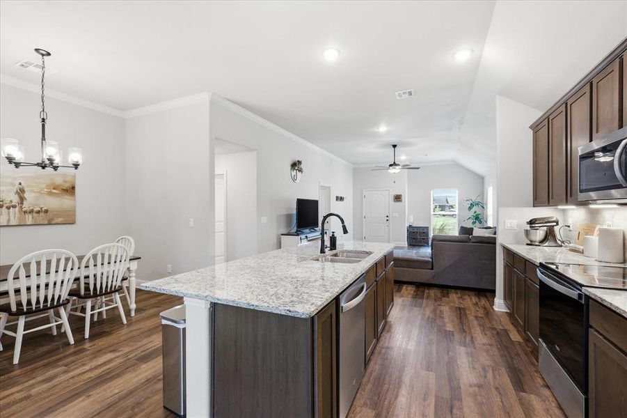 Spacious island kitchen located adjacent to the living room, offering an open layout ideal for cooking, gathering, and entertaining.