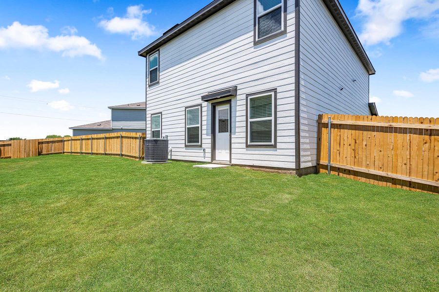 A spacious, enclosed backyard provides privacy and room for outdoor enjoyment.