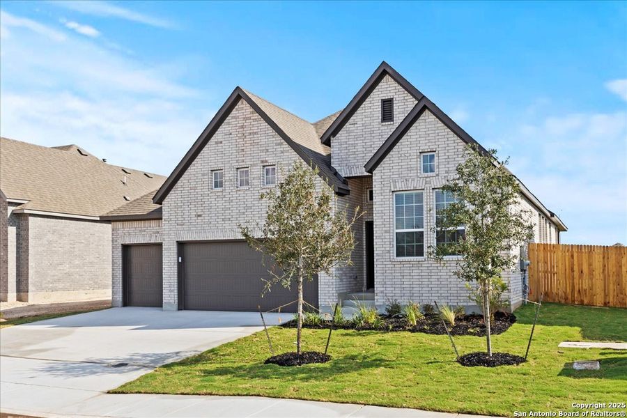 Front exterior of a new home in Village at Three Oaks, Seguin, TX, highlighting curb appeal (Image 1). Front exterior of a new home in Village at Three Oaks, Seguin, TX, highlighting curb appeal (Image 1).