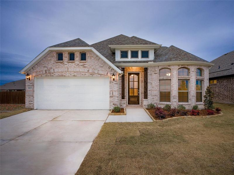 View of front facade with a front yard and a garage