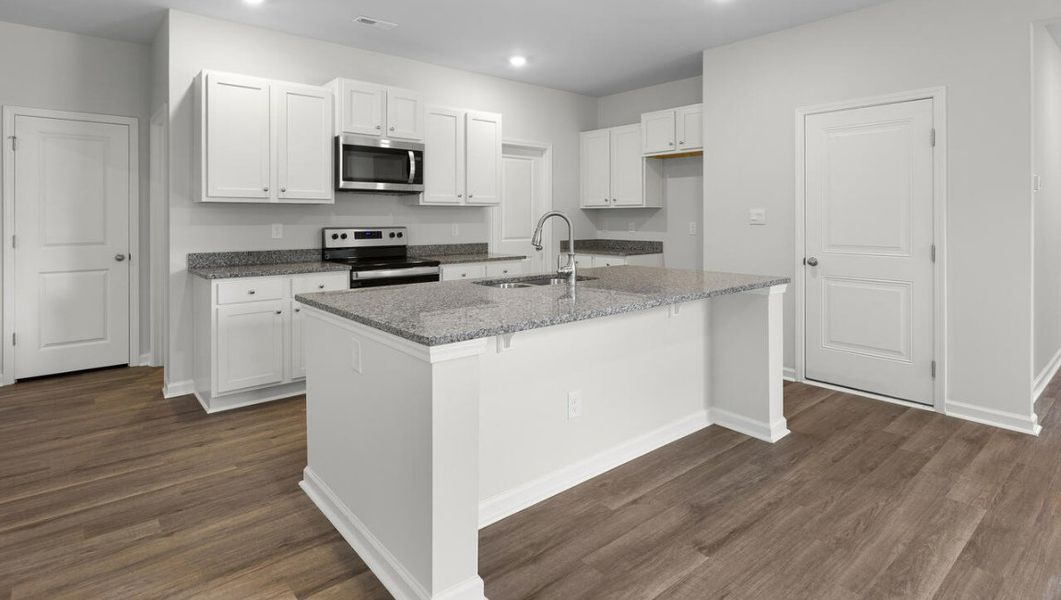 Representative furnished interior of a home built from the WOODSTOCK by D.R. Horton in Surfside Landing, Hubert (Image 5).