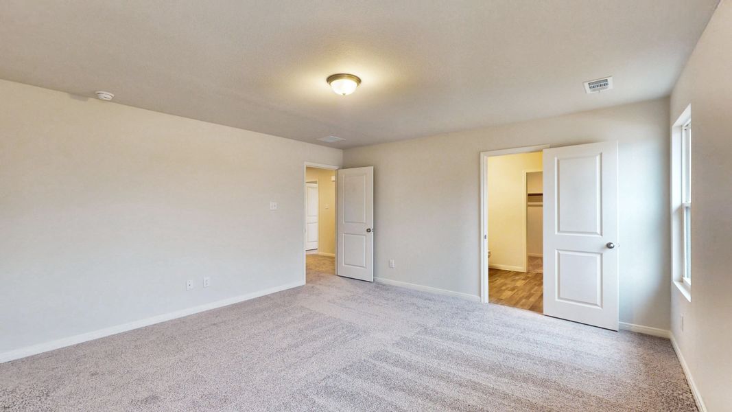 A hallway with white doors.