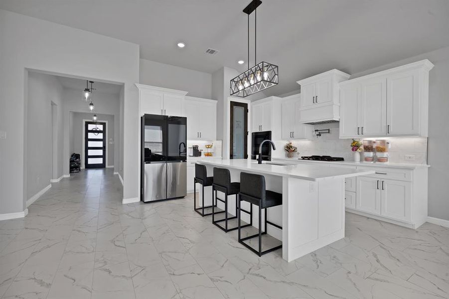 Kitchen featuring marble look floor tile, tasteful backsplash, smart refrigerator, and light countertops