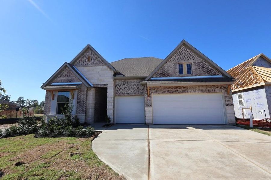 Front exterior of a new home in Grand Central Park 55' Homesites, Conroe, TX, highlighting curb appeal (Image 1). Front exterior of a new home in Grand Central Park 55' Homesites, Conroe, TX, highlighting curb appeal (Image 1).