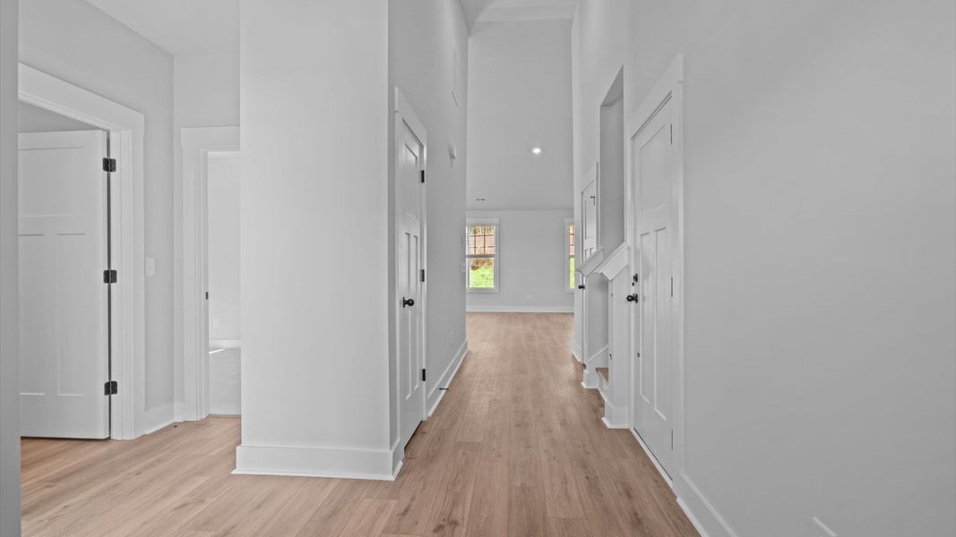 Memorable arrival experience with hardwood floors and elegant trim in the foyer