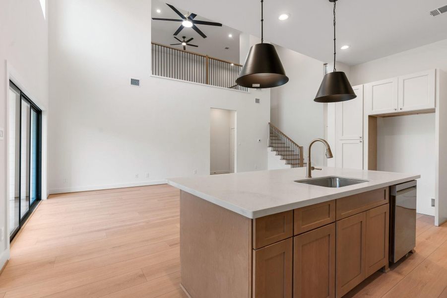 Enjoy a clear view from the stylish kitchen into the bright, double-height living room—an open and inviting space perfect for entertaining. Enjoy a clear view from the stylish kitchen into the bright, double-height living room—an open and inviting space perfect for entertaining.