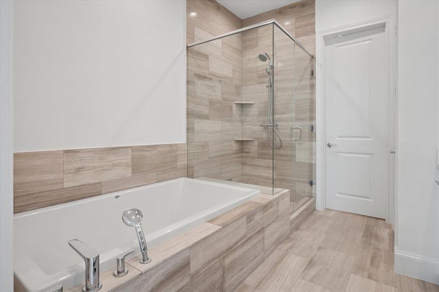 Bathroom with a stall shower and a garden tub