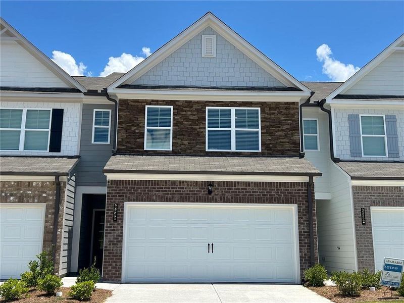Front exterior of a new home in Somerset at Riverbrook, Gainesville, GA, highlighting curb appeal (Image 18). Front exterior of a new home in Somerset at Riverbrook, Gainesville, GA, highlighting curb appeal (Image 18).