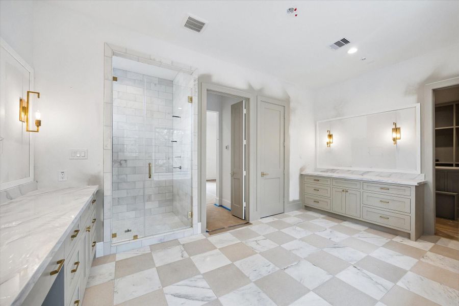 Primary bathroom with large walk-in shower. Pictured April 2026.