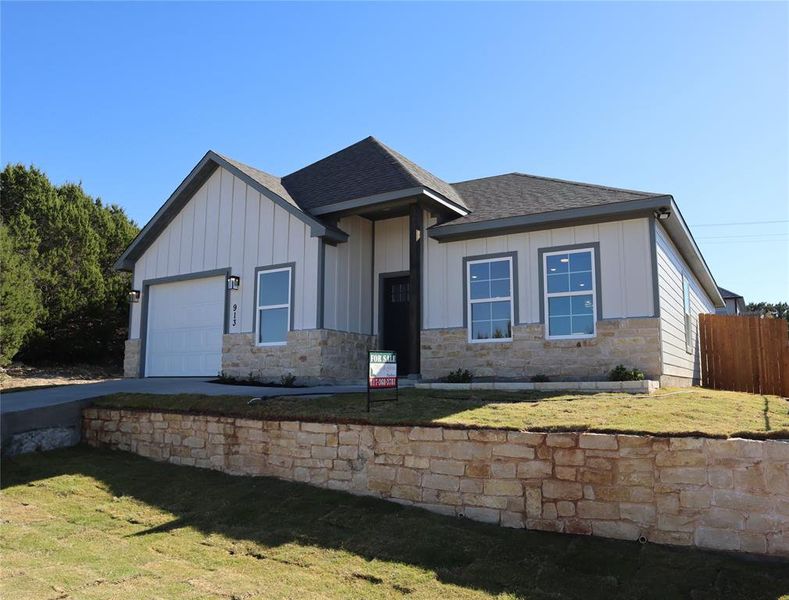 View of Front Facade with a garage and step yard