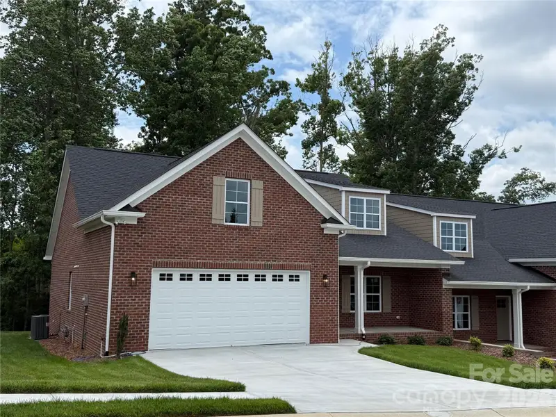 This brand new brick townhome has a 2 car garage...