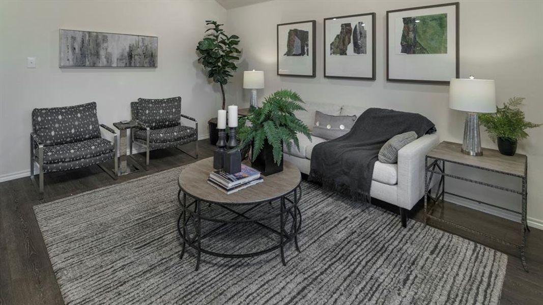 Living area featuring wood-finish flooring, light neutral wall tones, and recessed lighting Living area featuring wood-finish flooring, light neutral wall tones, and recessed lighting