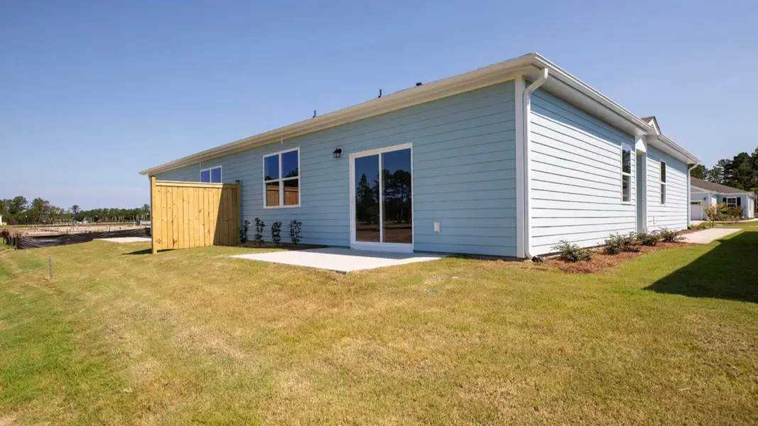 Exterior details and patio area of a home in Indigo Preserve Townhomes, Leland (Image 3).