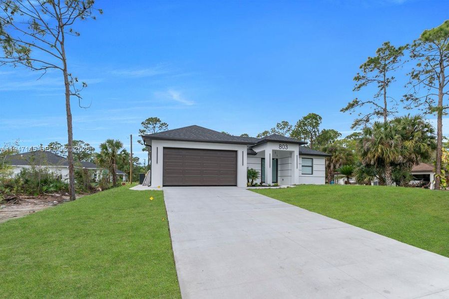 Front exterior of a new home in , Lehigh Acres, FL, highlighting curb appeal (Image 20).