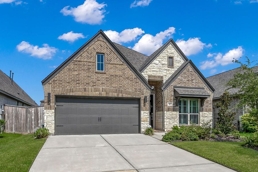 Front exterior of a new home in Grand Central Park 45', Conroe, TX, highlighting curb appeal (Image 21).