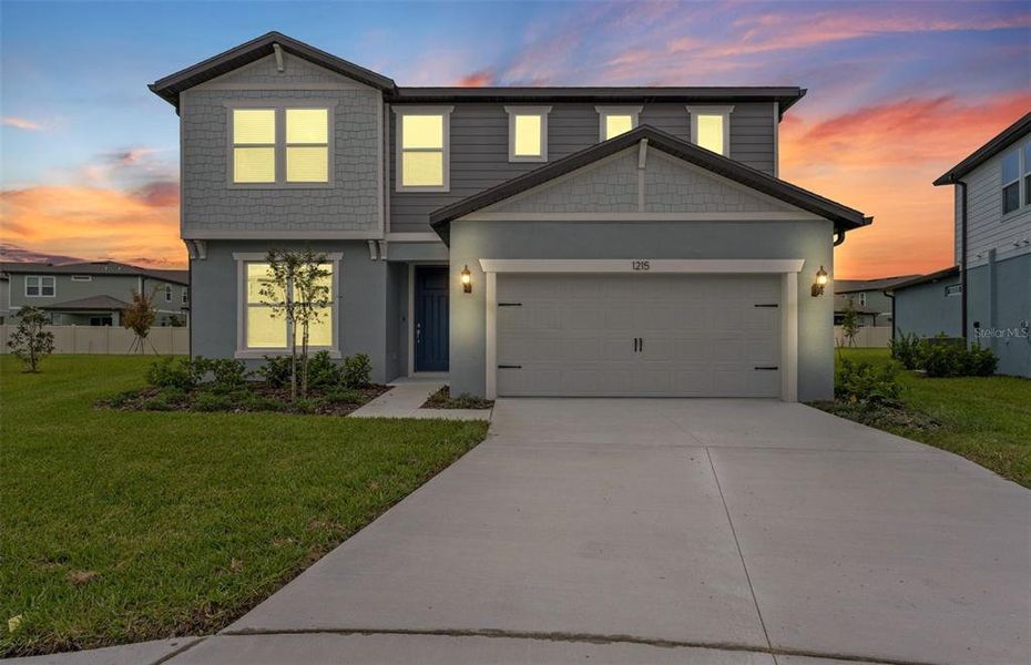 Front exterior of a new home in Riverwood, Zephyrhills, FL, highlighting curb appeal (Image 2).