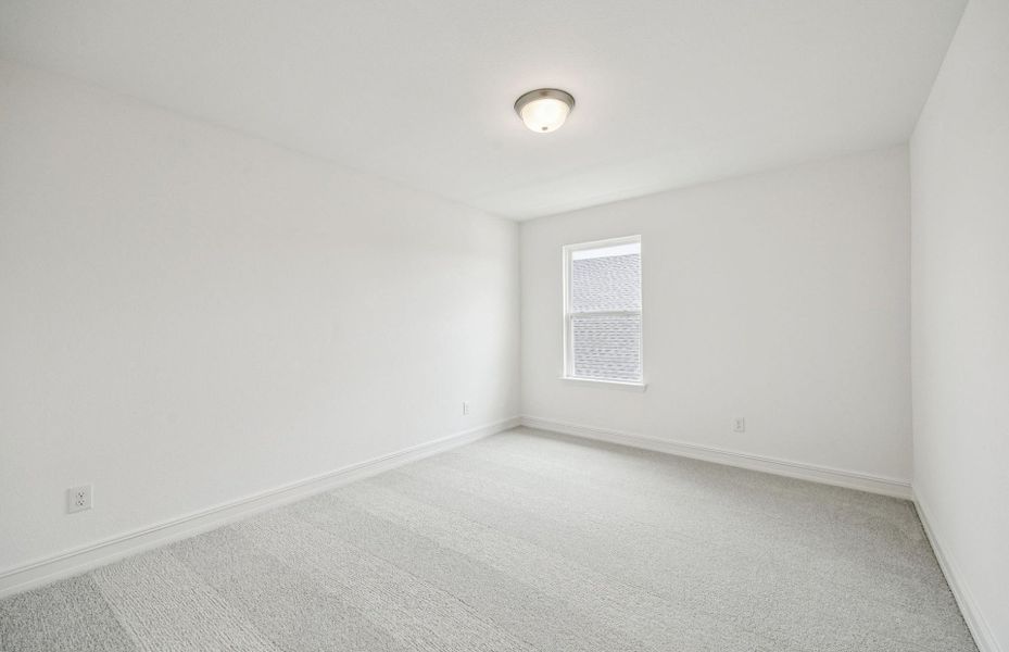 Comfortable secondary bedroom with generous closet space  *Real home pictured