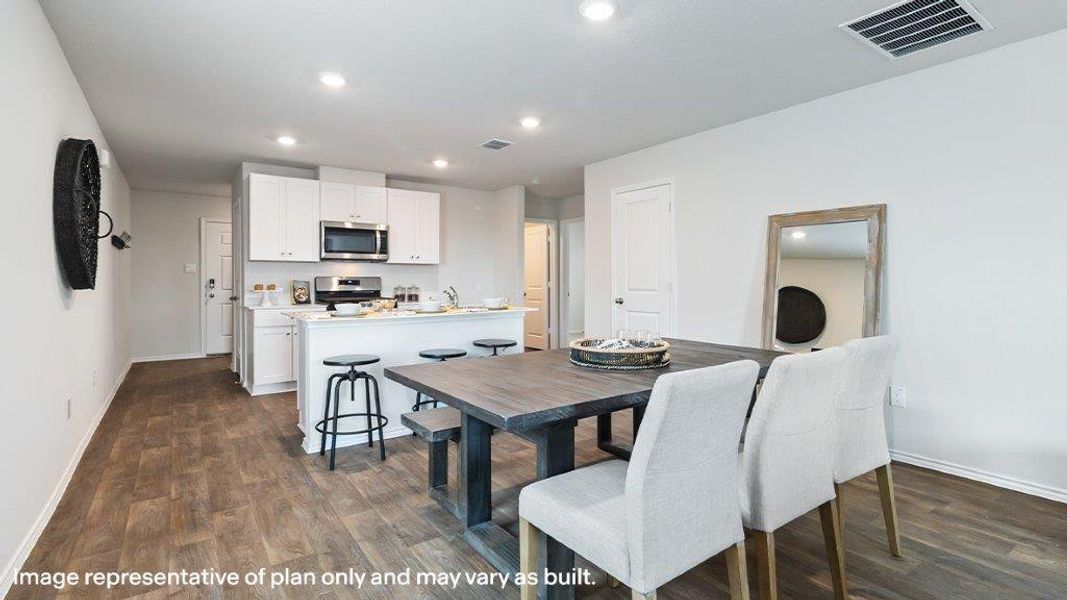 An inviting open-concept layout unites the dining space and a well-appointed kitchen. An inviting open-concept layout unites the dining space and a well-appointed kitchen.