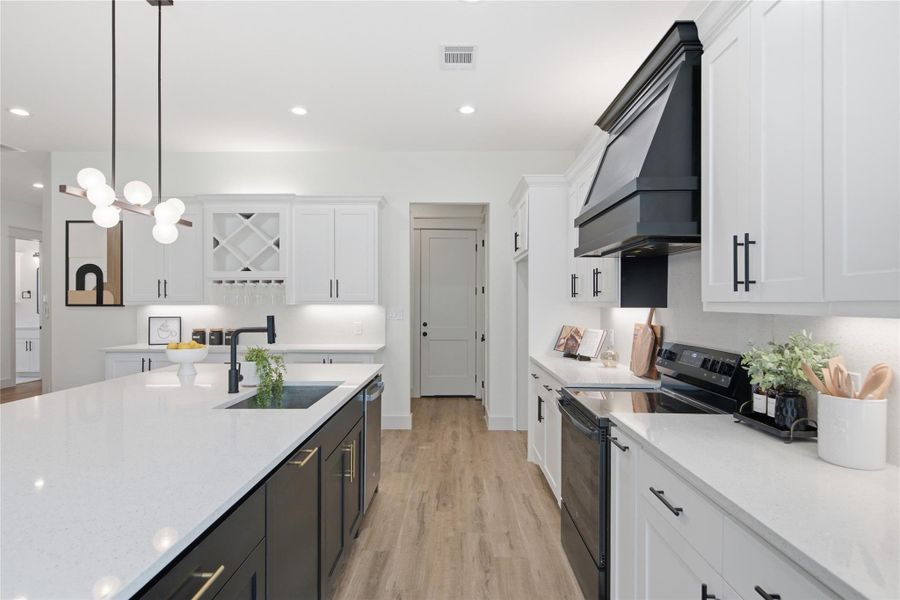 Culinary delights await in this bright kitchen with an expansive island and sophisticated finishes. Culinary delights await in this bright kitchen with an expansive island and sophisticated finishes.