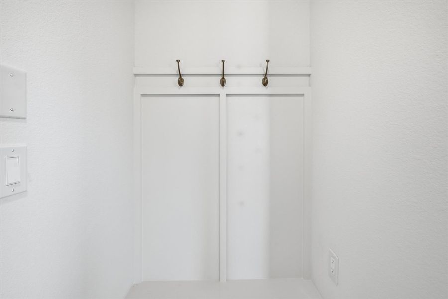 Charming nook with built-in hooks, perfect for hanging coats or bags in a convenient entryway space.