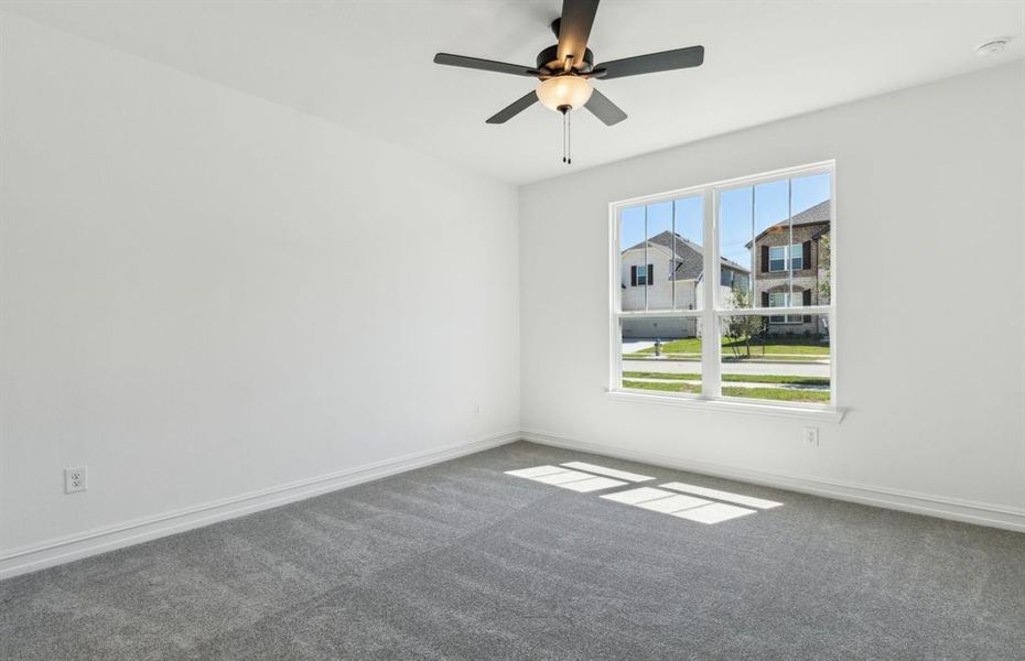 Spacious owner's suite bathed in natural light *Real home pictured