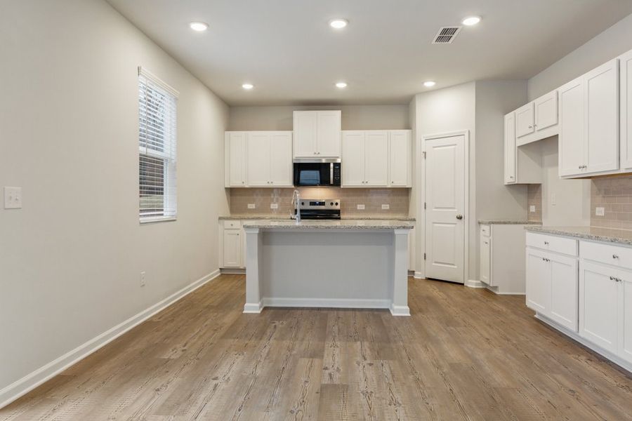 A kitchen with white cabinets. A kitchen with white cabinets.