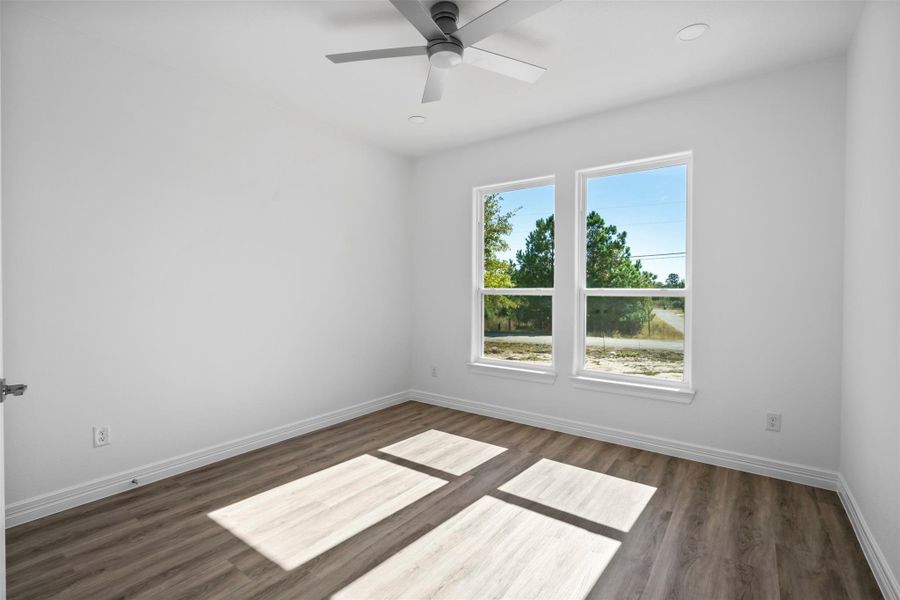 Unfurnished room featuring dark wood-type flooring, a ceiling fan, and recessed lighting