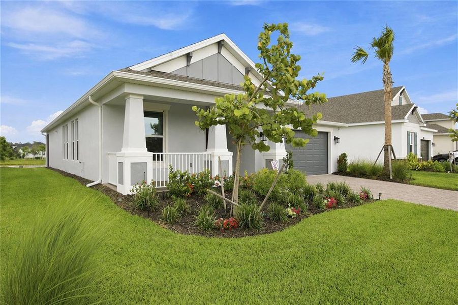 Front exterior of a new home in The Cove at West Port, Port Charlotte, FL, highlighting curb appeal (Image 2). Front exterior of a new home in The Cove at West Port, Port Charlotte, FL, highlighting curb appeal (Image 2).