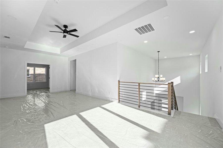 Spare room featuring a chandelier, a ceiling fan, and recessed lighting Spare room featuring a chandelier, a ceiling fan, and recessed lighting