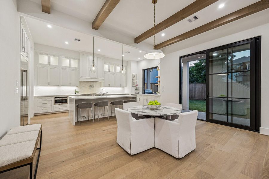 Breakfast Area with a 20" Wide Burnished Brass Bowl Pendant Light. There is a set of sliding doors that lead out the covered patio and a large yard with room enough for a pool. Breakfast Area with a 20" Wide Burnished Brass Bowl Pendant Light. There is a set of sliding doors that lead out the covered patio and a large yard with room enough for a pool.