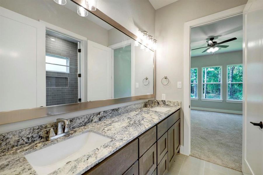 Your secondary bath also includes a dual vanity with tons of storage space.