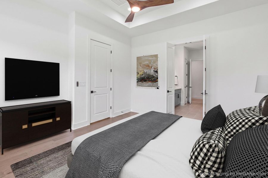 Recessed ceiling with a dark wood-finish ceiling fan and light-toned wood-finish flooring Recessed ceiling with a dark wood-finish ceiling fan and light-toned wood-finish flooring