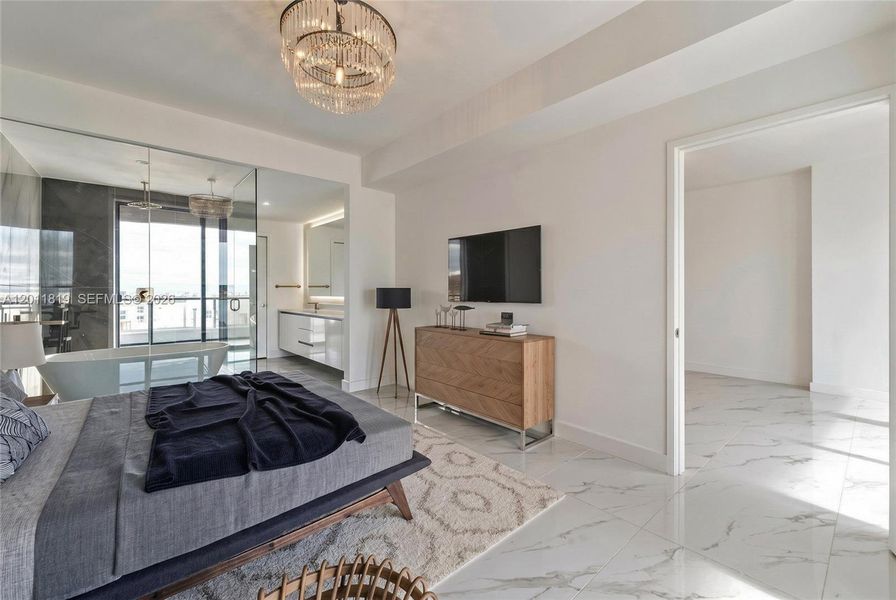 Serene primary suite offering unobstructed water views, direct terrace access, oversized walk-in closets, and floor-to-ceiling windows for a true 'mansion in the sky' feel. Image is virtually staged.