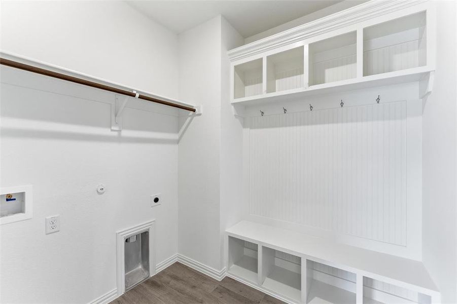 Laundry area featuring wood finished floors, hookup for a gas dryer, hookup for an electric dryer, and hookup for a washing machine