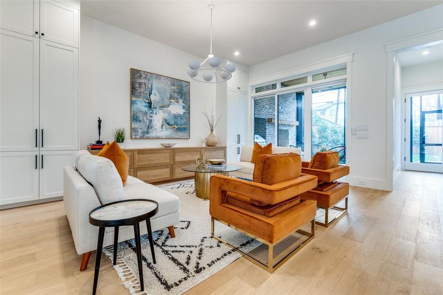 Living area with an inviting chandelier and light hardwood / wood-style flooring