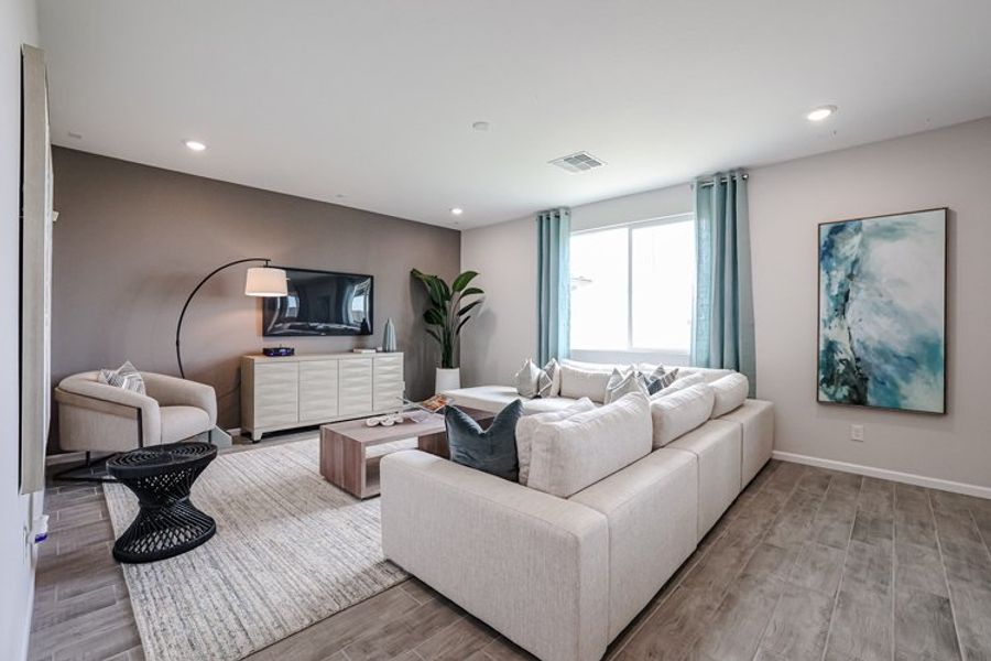 A living room with a white couch and a tv. A living room with a white couch and a tv.