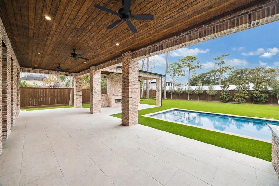 Imagine the unforgettable gatherings you could host in this stunning outdoor space! With a spacious covered patio, built-in fireplace, and a sparkling pool, it's perfect for entertaining or relaxing year-round.