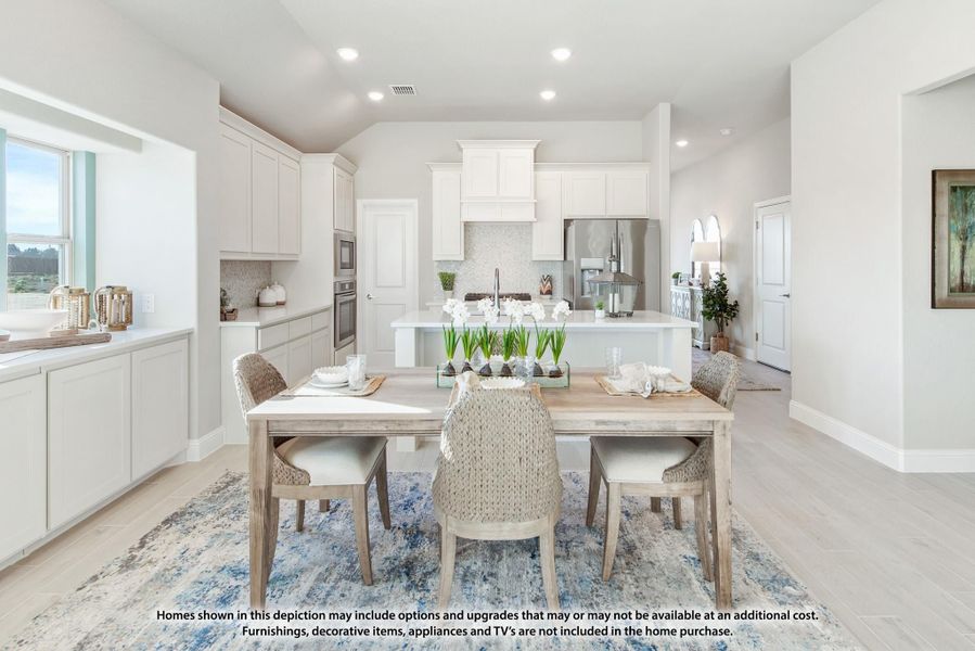 Open dining area with wood table and woven chairs flowing into white kitchen with center island Open dining area with wood table and woven chairs flowing into white kitchen with center island