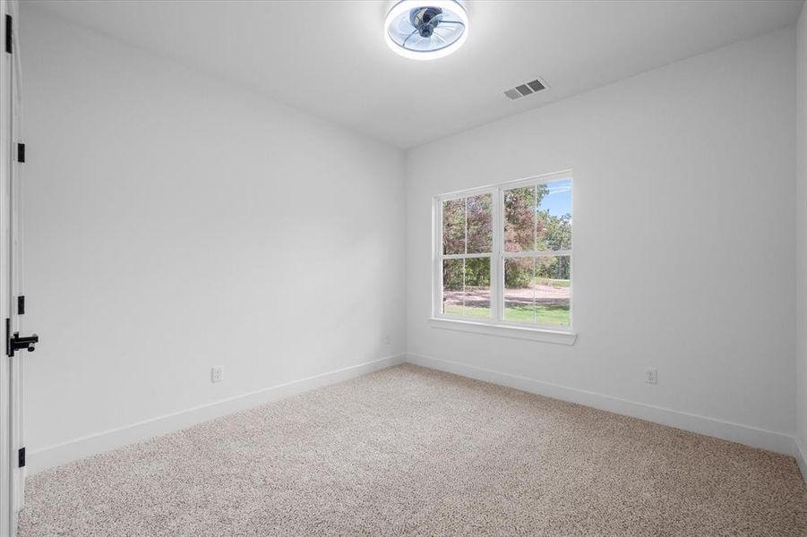 Carpeted empty room featuring baseboards Carpeted empty room featuring baseboards