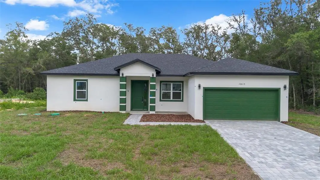 Front exterior of a new home in , Citrus Springs, FL, highlighting curb appeal (Image 17).