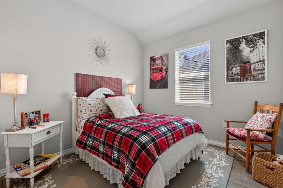 A comforting bedroom features warm plaid bedding and light-filled windows, creating a cozy and inviting atmosphere. A comforting bedroom features warm plaid bedding and light-filled windows, creating a cozy and inviting atmosphere.