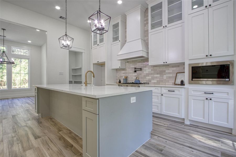 Kitchen features quartz countertops, soft closing real wood cabinets, farmhouse sink and potfiller over gas stove Kitchen features quartz countertops, soft closing real wood cabinets, farmhouse sink and potfiller over gas stove